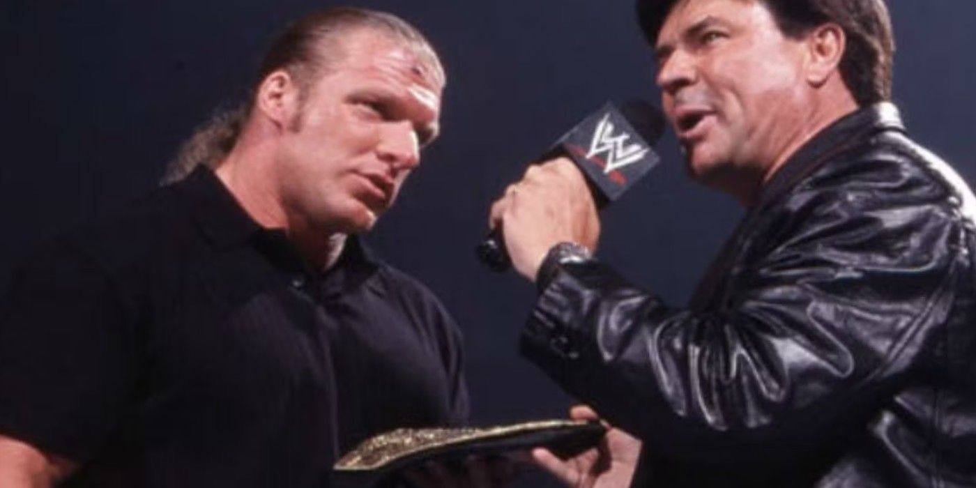 Eric Bischoff hands the WWE World Heavyweight Championship to Triple H on Monday Night Raw