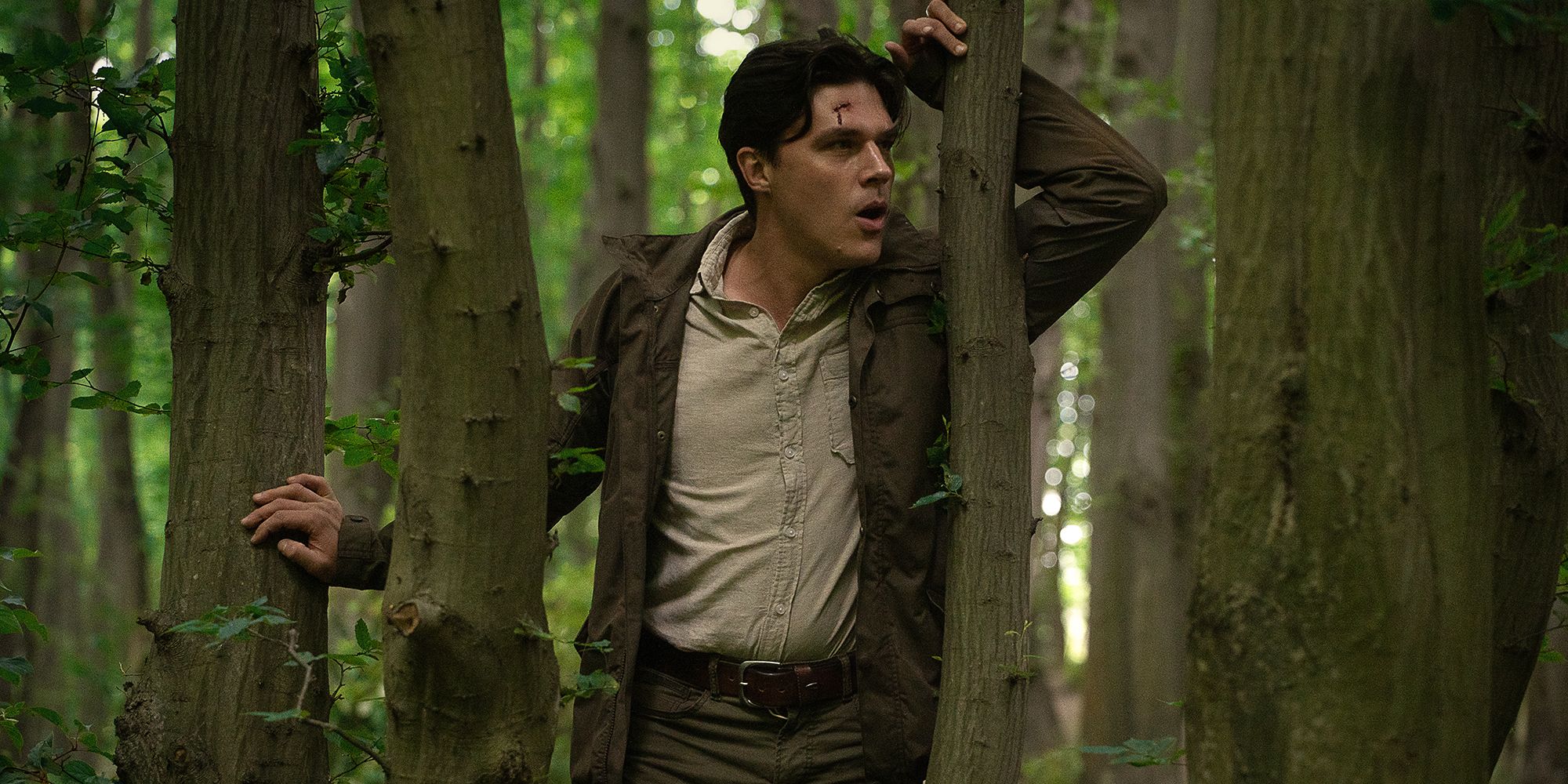 Finn Wittrock leaning against a tree in Don't Move