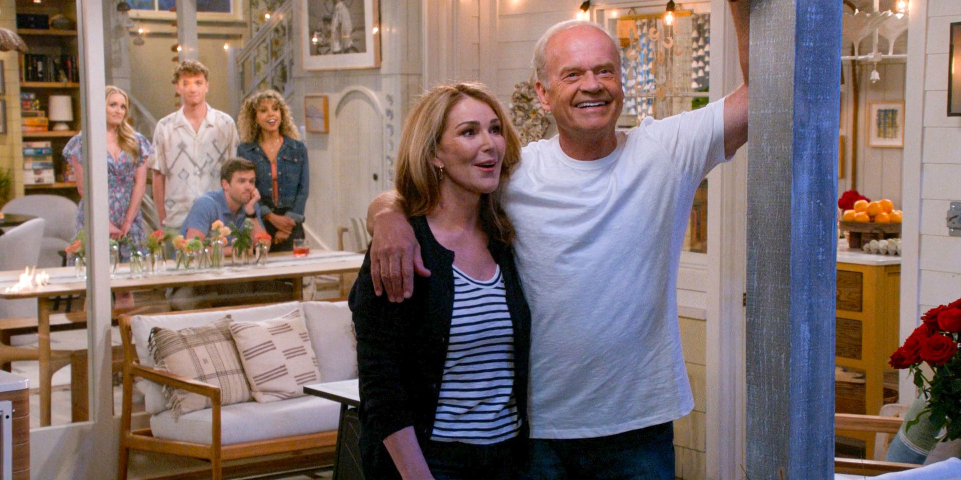 Roz Doyle (Peri Gilpin) and Frasier (Kelsey Grammer) enjoying the fireworks while the guys watch happily in Frasier (2023) Season 2 Episode 6