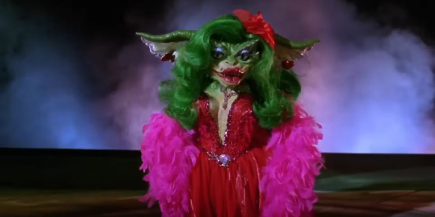 Greta wearing a pink boa and dancing in Gremlins 2