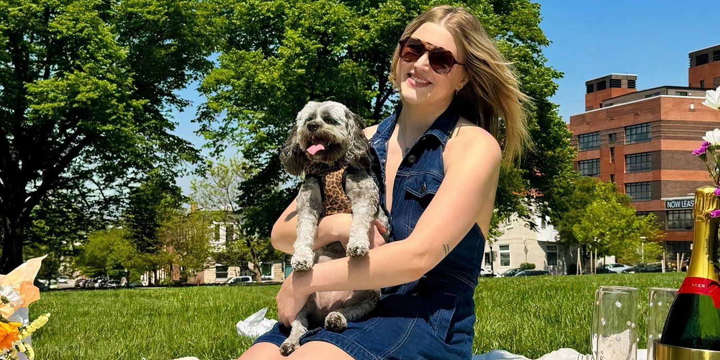 Love is blind Hannah Jiles holding a puppy and sitting in the grass