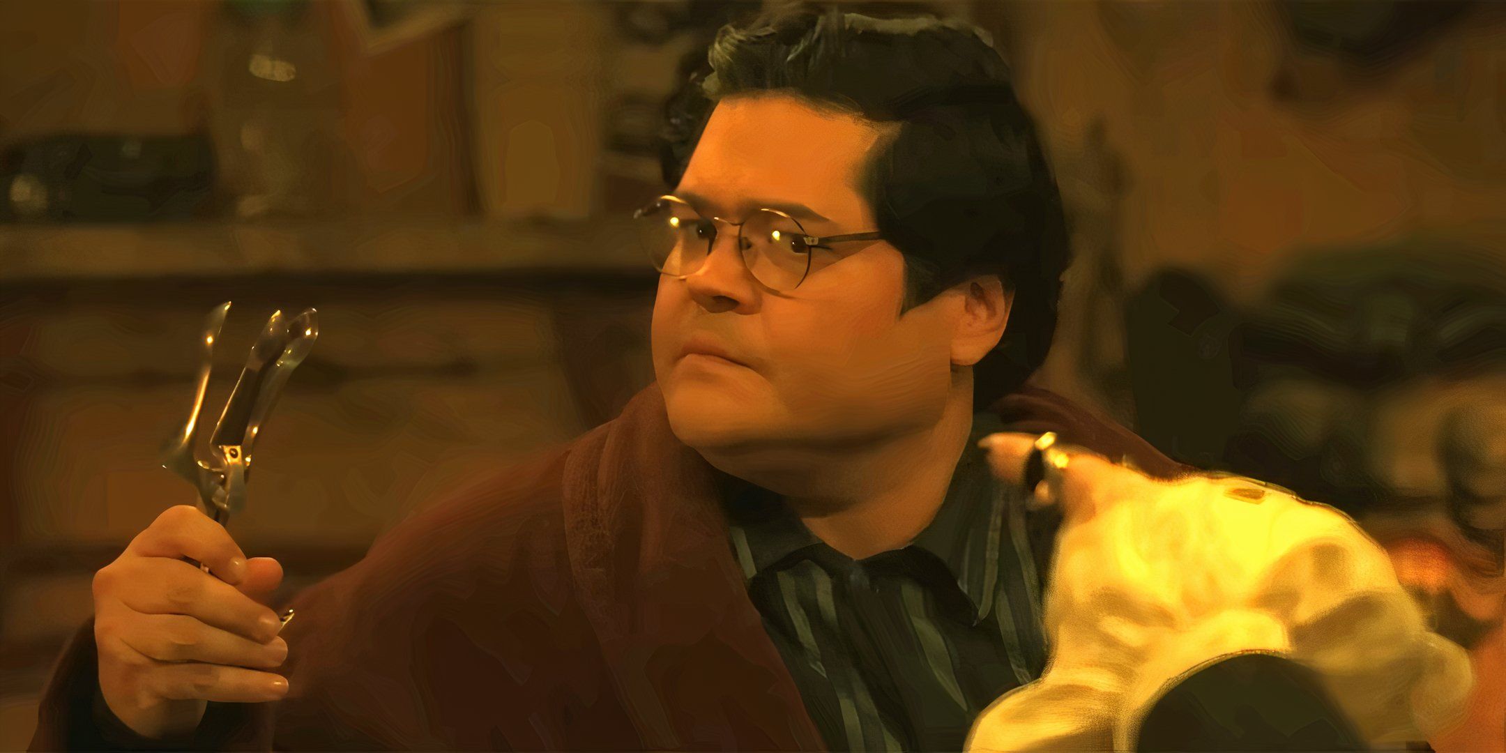 Harvey Guillén as Guillermo looking uncertain while holding a medical device in What We Do in the Shadows season 6