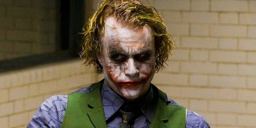 Heath Ledger as the Joker in The Dark Knight 2008 smiling in prison.