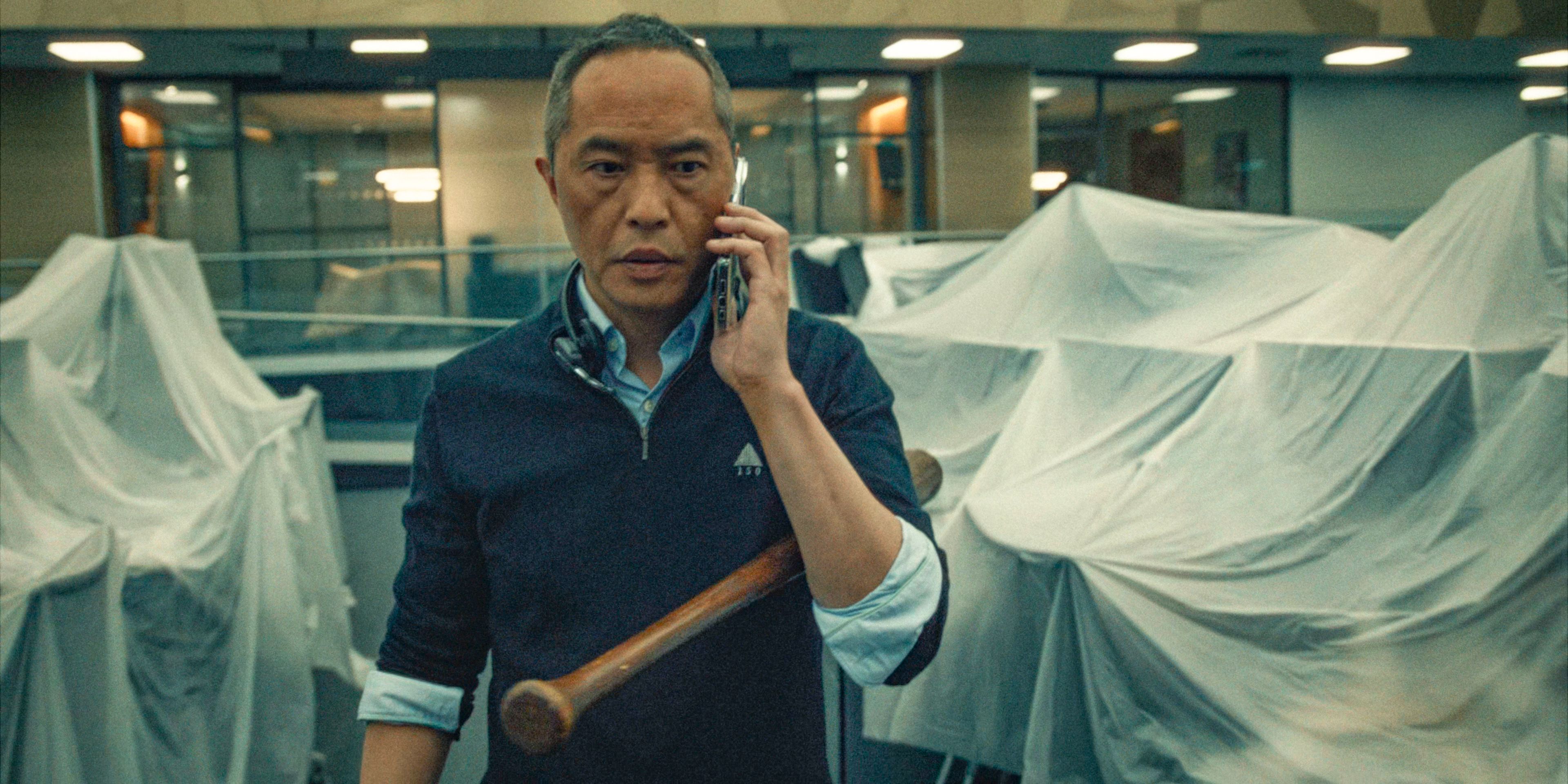 Eric talks on the phone in a closed down office in Industry