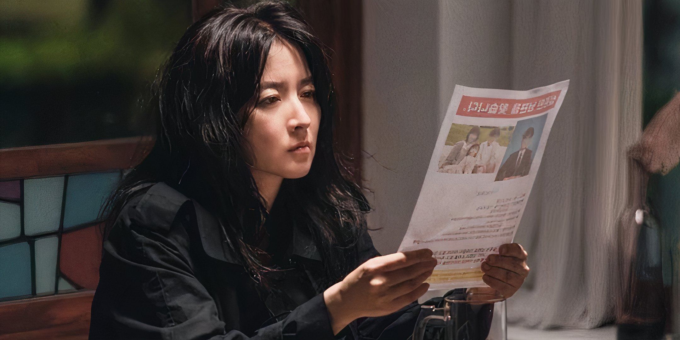 A woman holds up a missing person's flyer. 