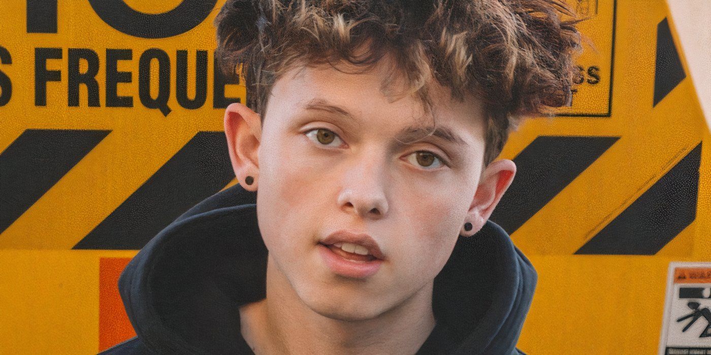 Jacob Sartorius posing in front of a warning sign