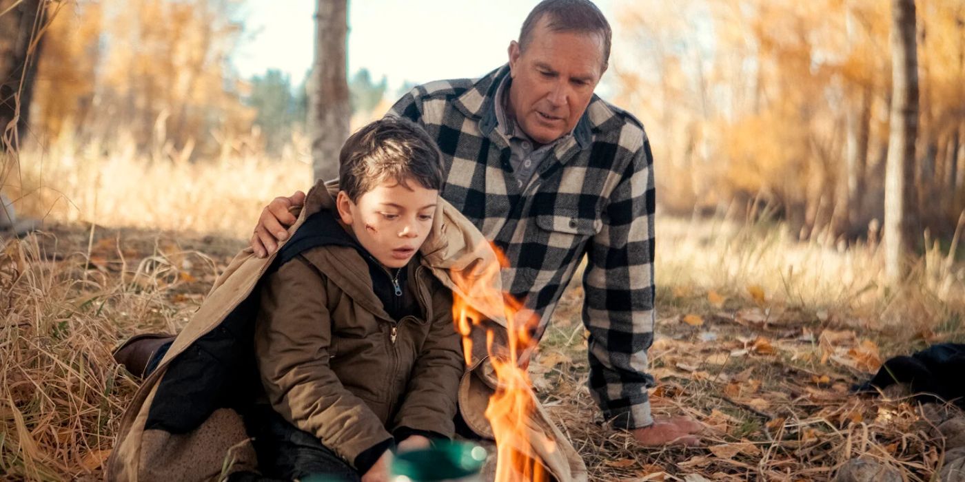 John (Kevin Costner) helping Tate (Brecken Merrill) making a fire in the woods in Yellowstone