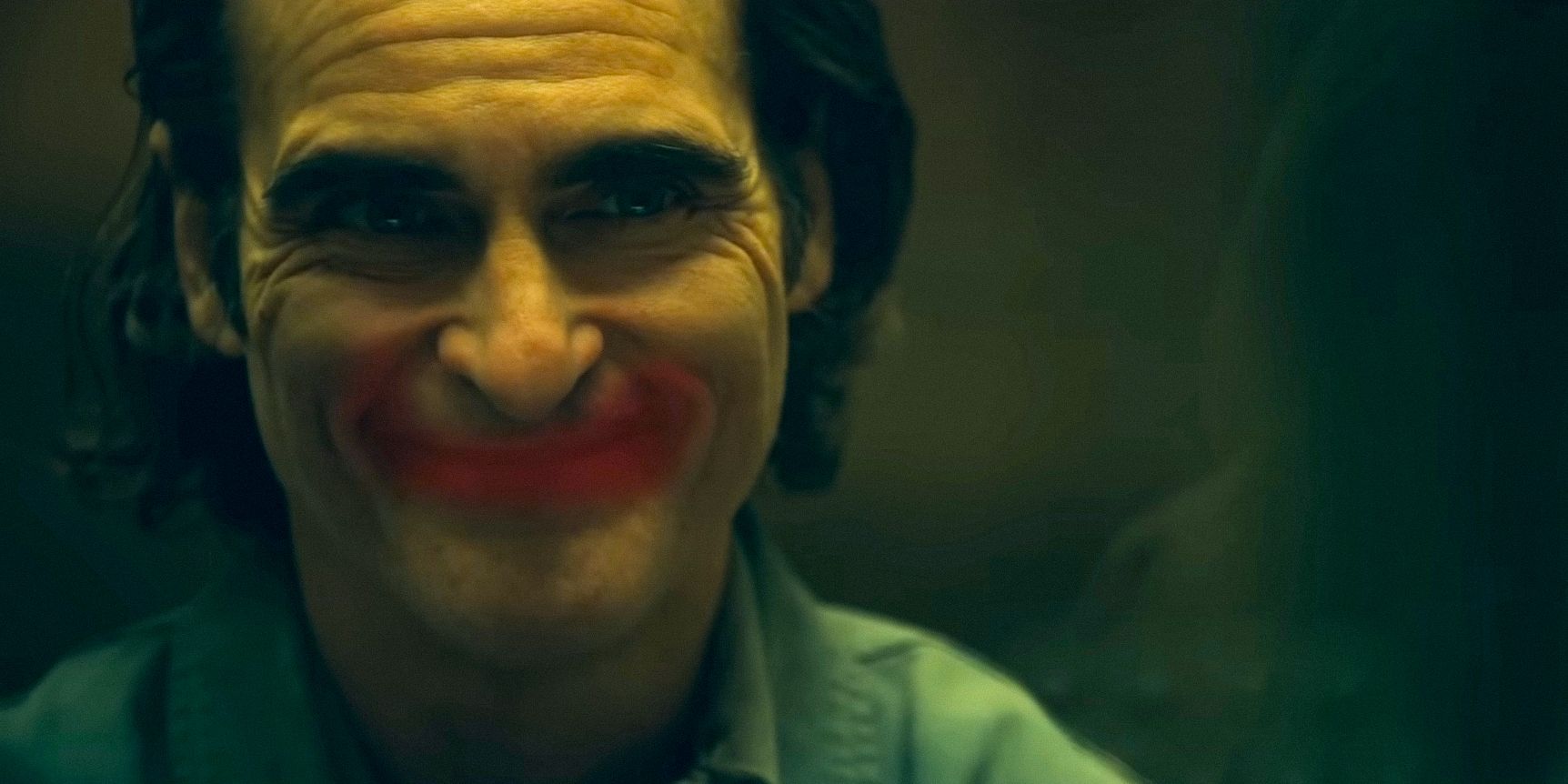 Arthur Fleck/Joker (Joaquin Phoenix) with a smile painted with red lipstick in Joker: Folie à Deux