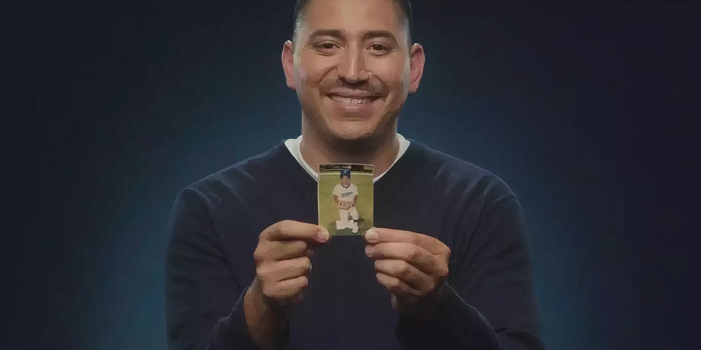 Juan Catalan holding up a picture of himself as a young boy in an LA Dodgers uniform in Long Shot