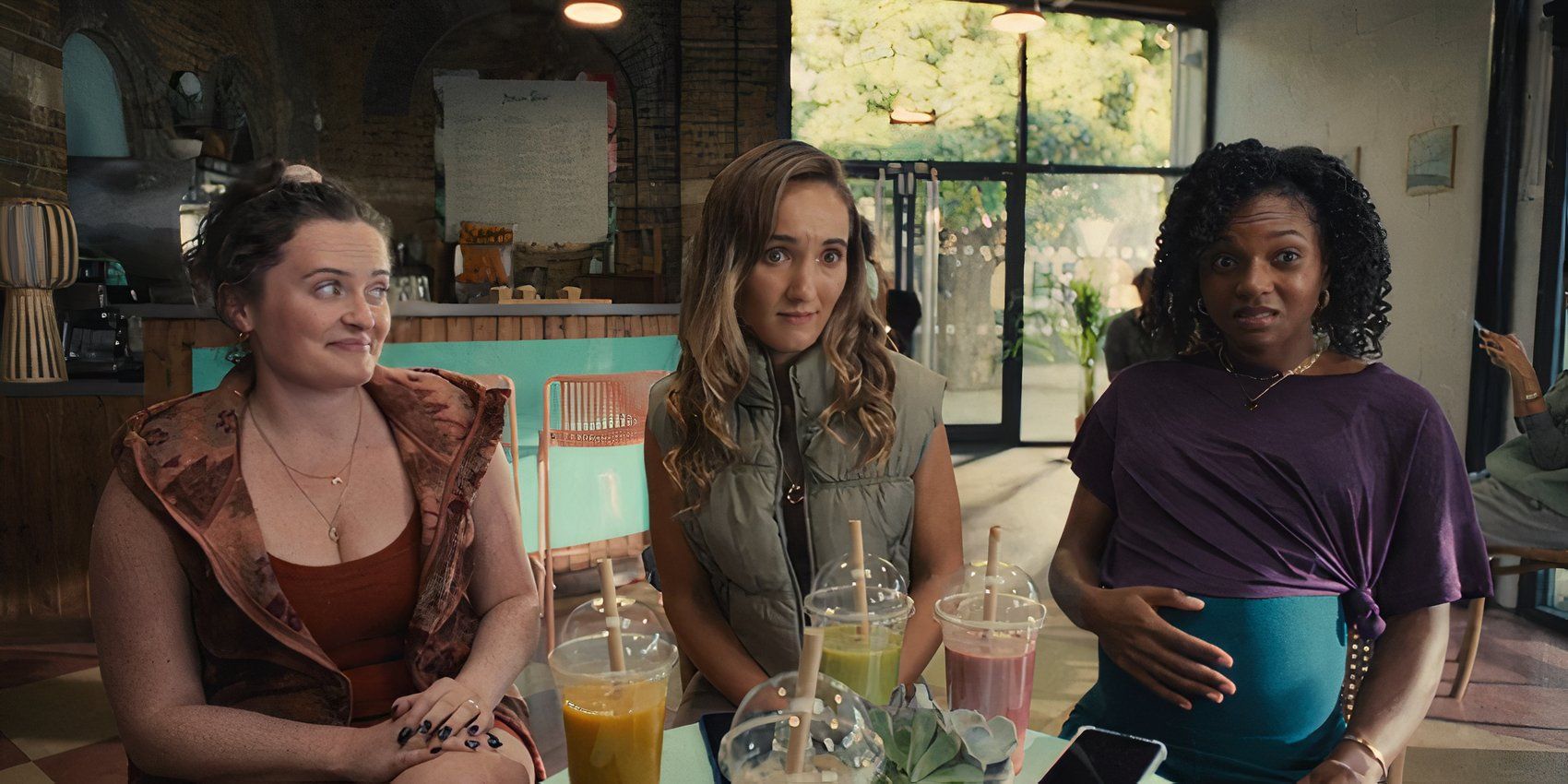 Julia's friends sitting across from Rhiannon in Sweetpea episode 4