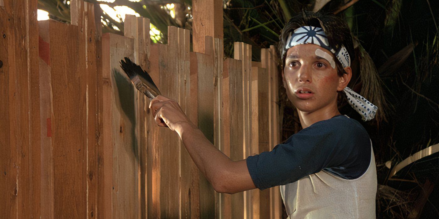 Ralph Macchio as Daniel LaRusso painting a fence in The Karate Kid (1984)