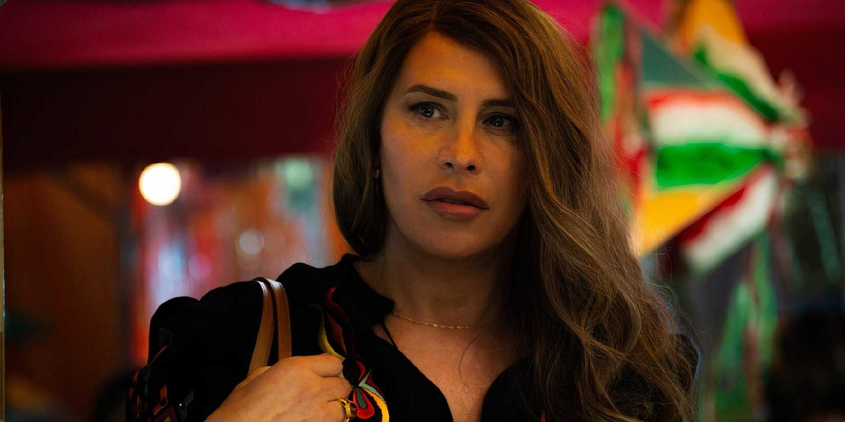 Karla Sofí Gascón holding her bag in Emilia Pérez