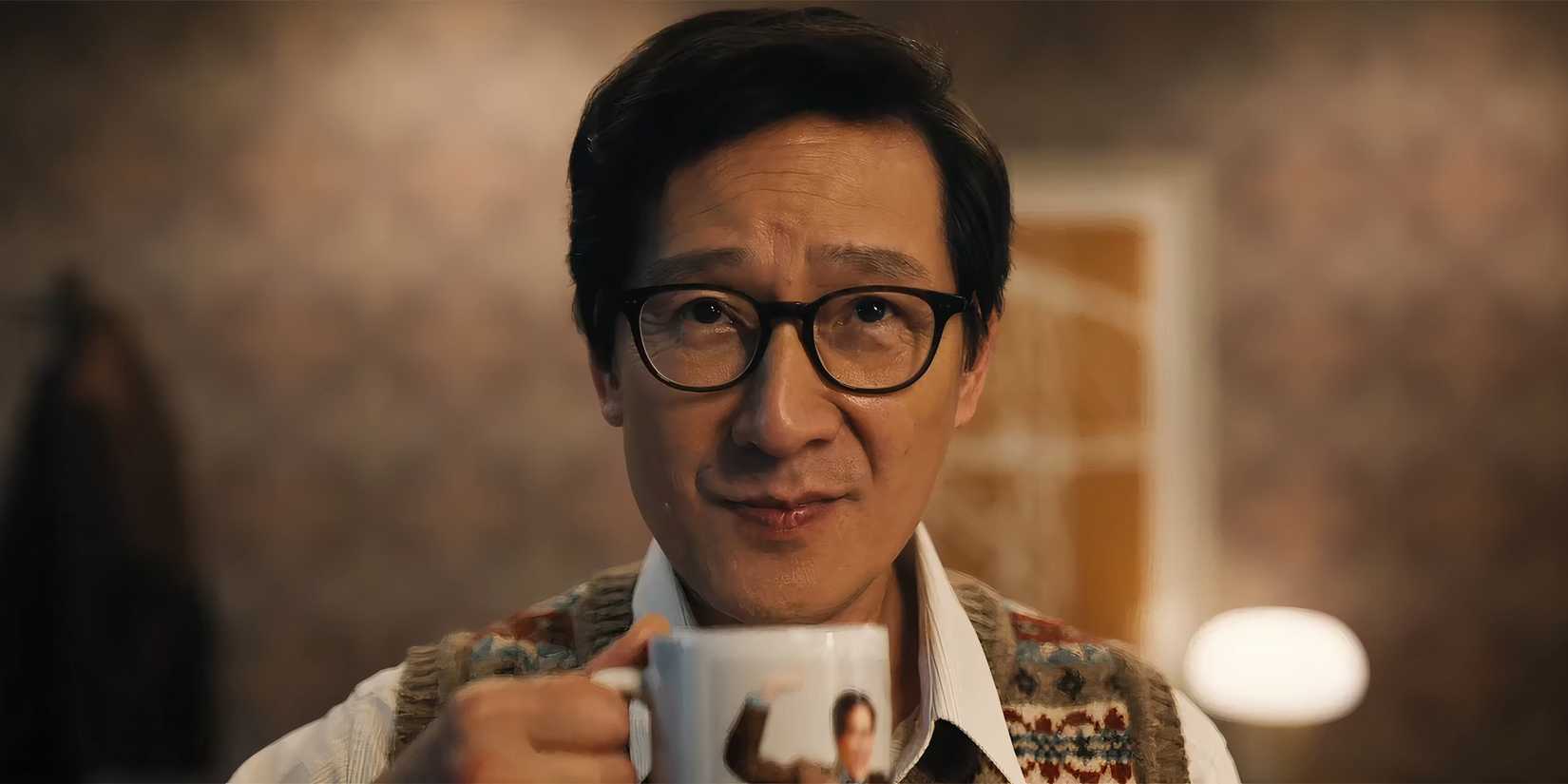 Ke Huy Quan as Marvin looking confident while holding a coffee mug in Love Hurts