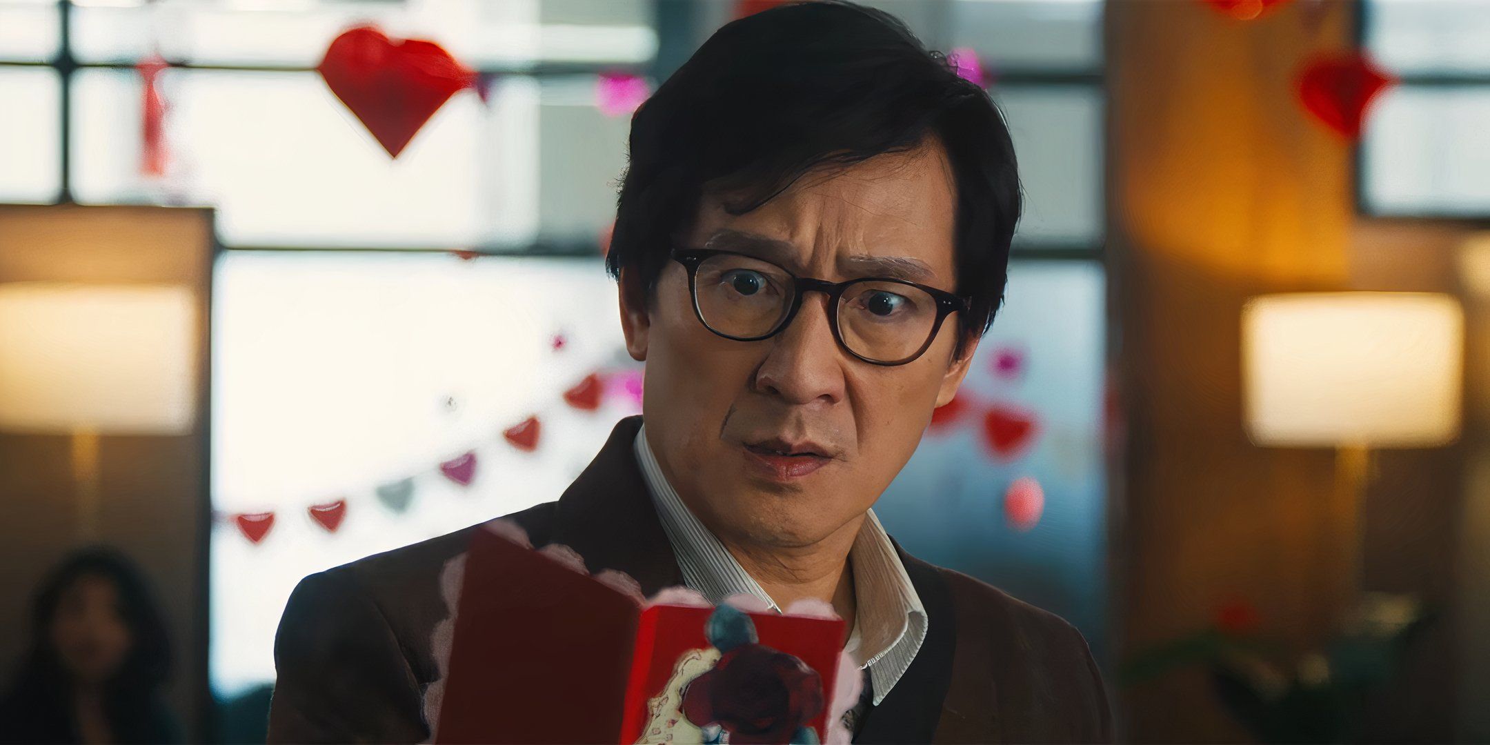 Ke Huy Quan as Marvin looking worried while reading a Valentine's Day card in Love Hurts