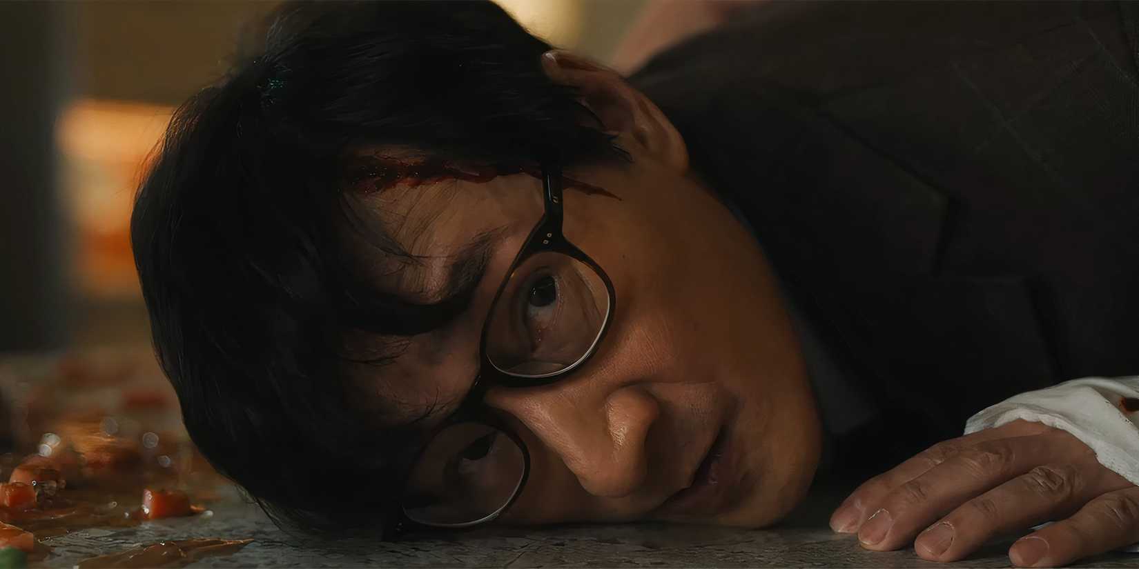 Ke Huy Quan's Marvin laying on a counter about to fight in Love Hurts