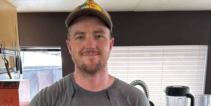 Keith Allen in Below Deck Sailing Yacht in a hat up close soft smiling