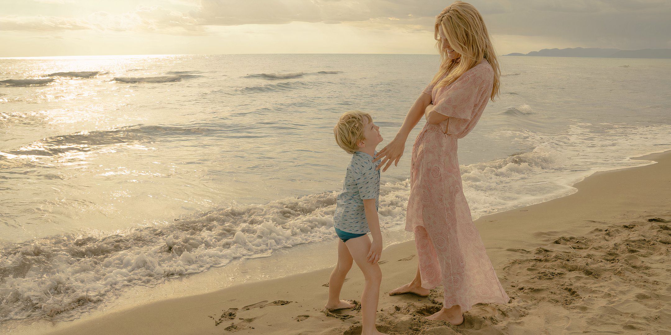 Leila George as Catherine with Nicholas as a young boy on the beach in Disclaimer episode 2