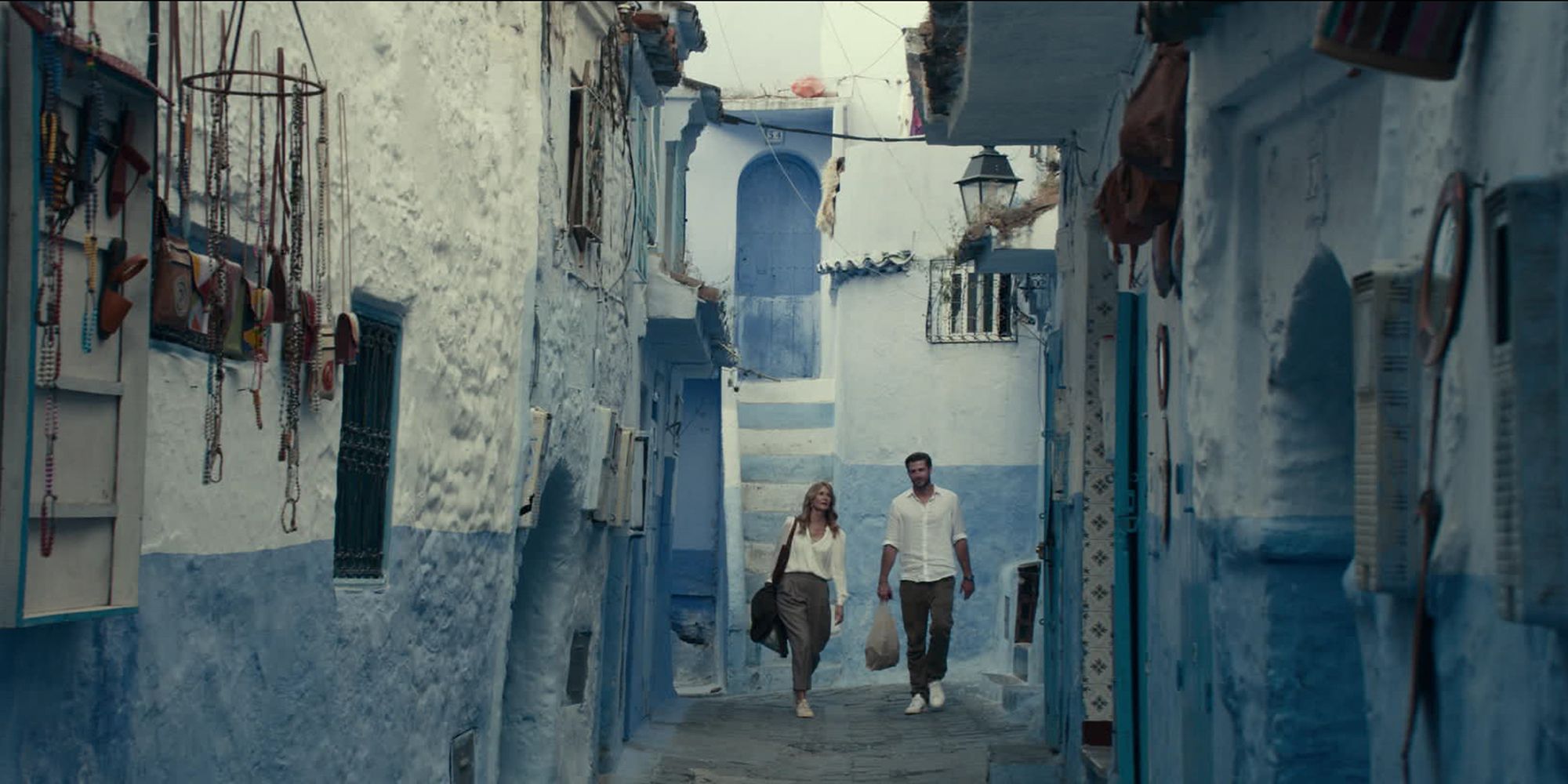 Liam Hemsworth & Laura Dern walking down the streets of Morocco in Lonely Planet