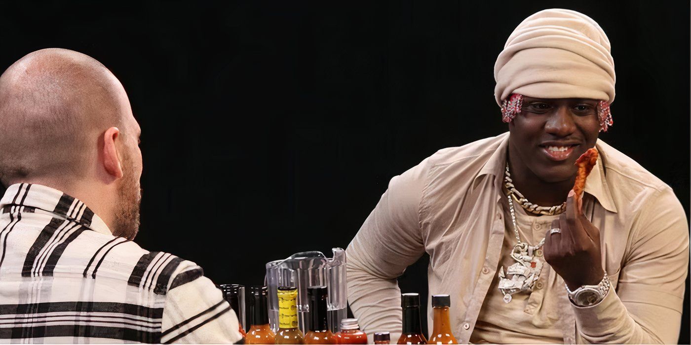 Lil Yachty looking at a hot wing on Hot Ones