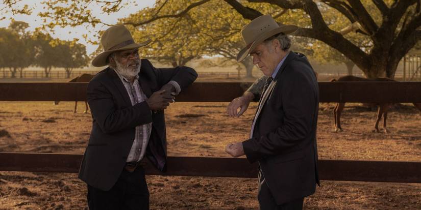 Characters leaning against a fence in Territory