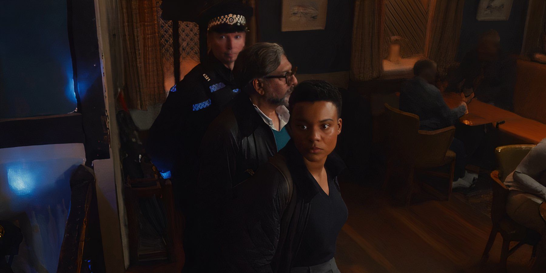 Marina (Leah Harvey) looking at Rhiannon while standing next to police officers in Sweetpea