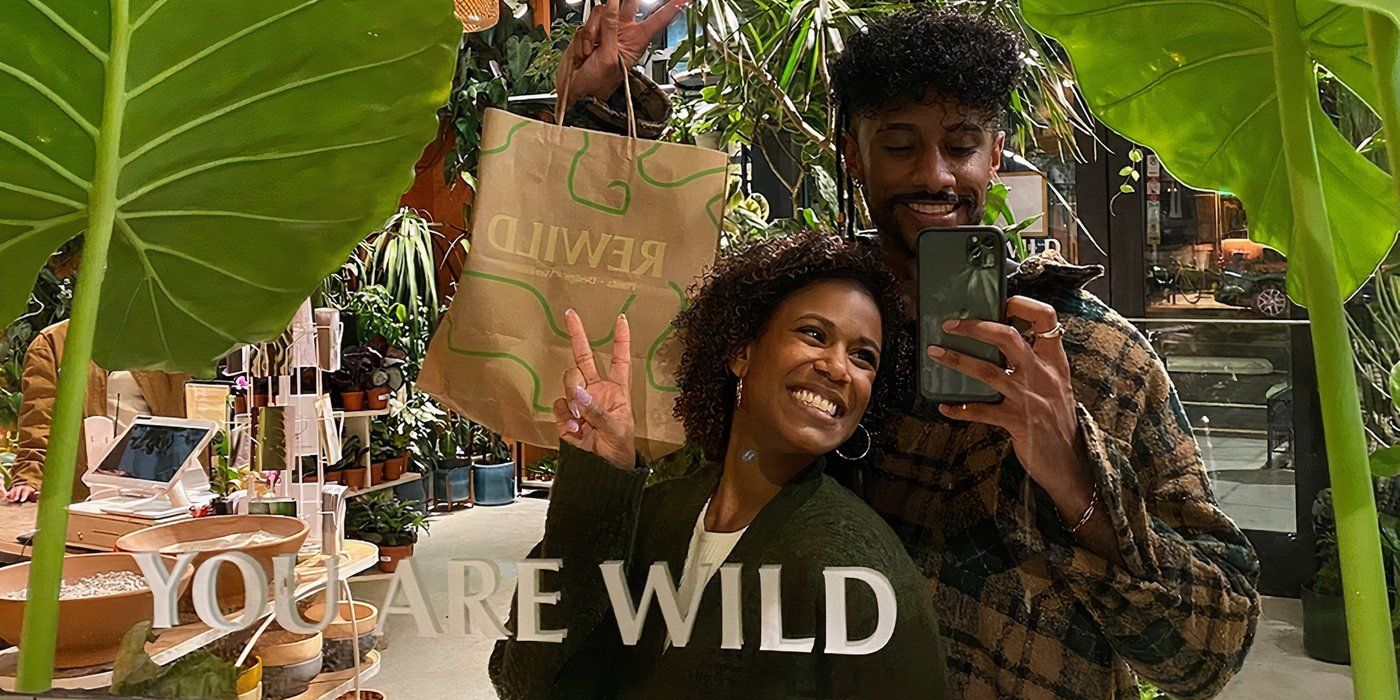 Love Is Blind season 7 Marissa George & Ramses Prashad smiling while taking a mirror selfie with Marissa showing the peace sign while there's a "you're wild" sign in the photo