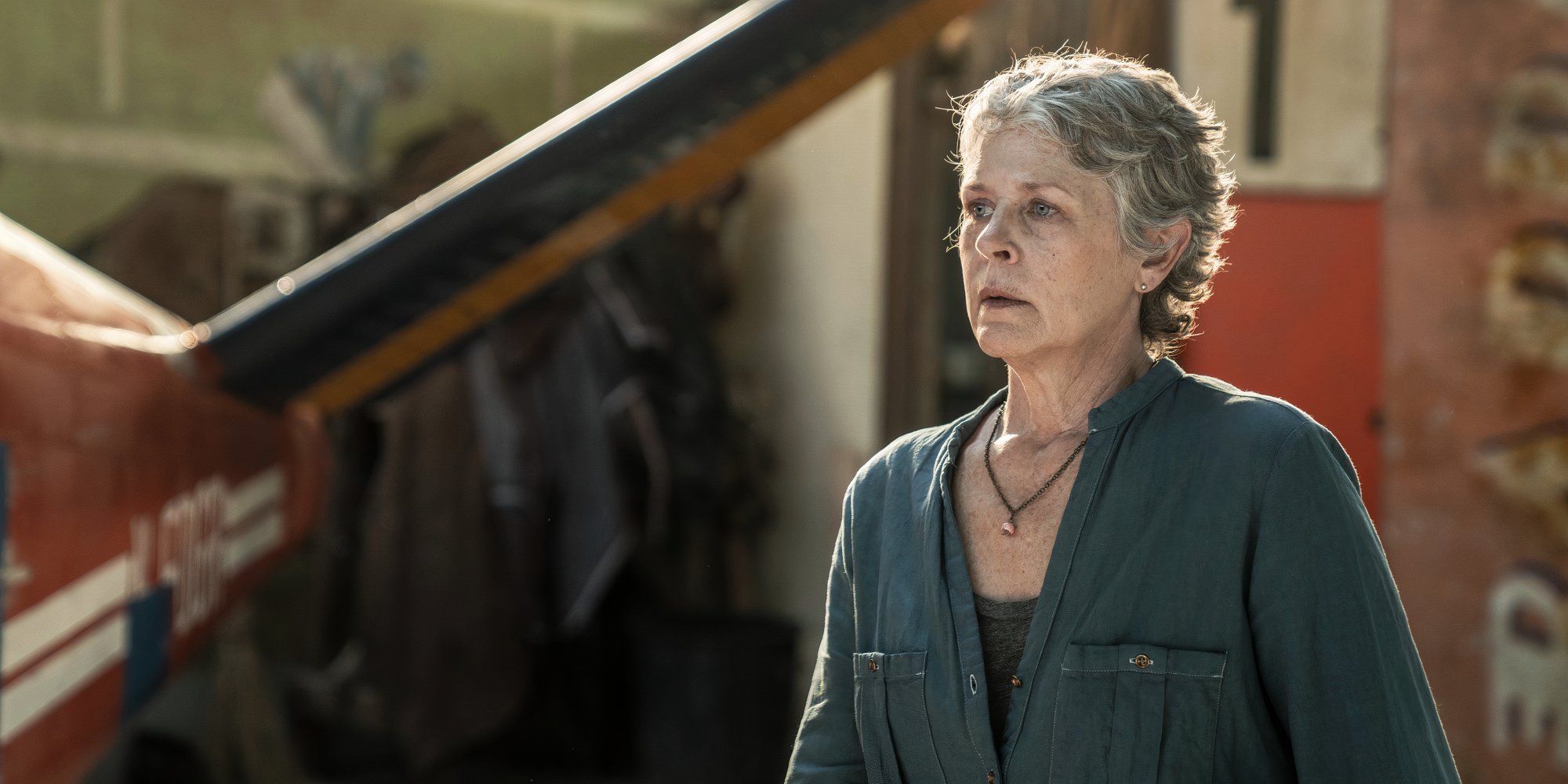 Melissa McBride as Carol walking towards Ash's plane in The Walking Dead Daryl Dixon season 2