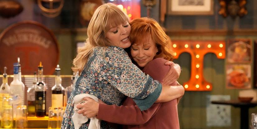 Melissa Peterman as Gabby and Reba McEntire as Bobbie hugging in Happy's Place