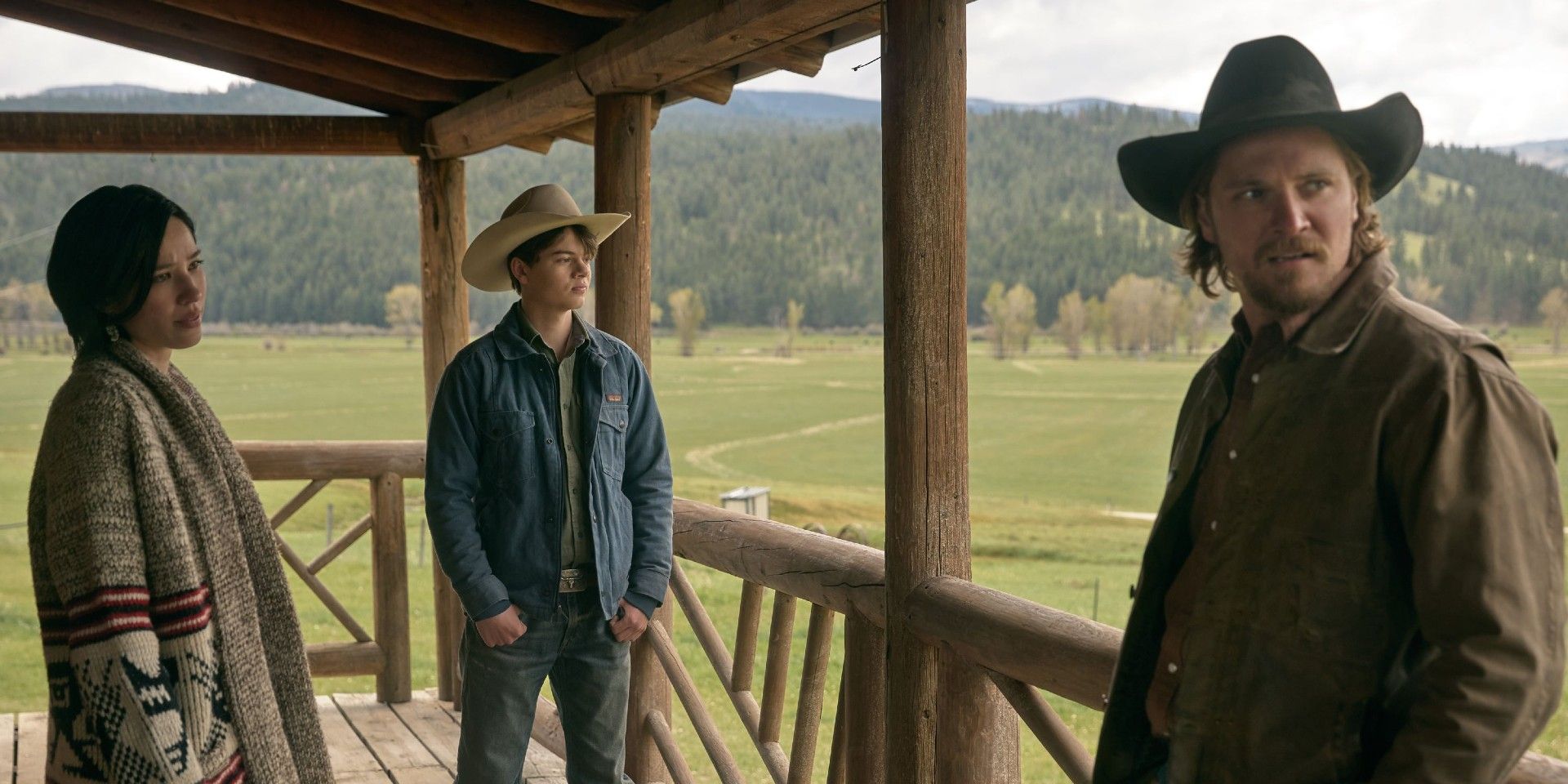 Monica, Kayce, and a young teen stand on a porch in Yellowstone