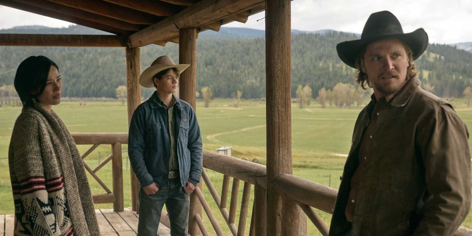 Monica, Kayce, and a young teen Tate Dutton stand on a porch in Yellowstone