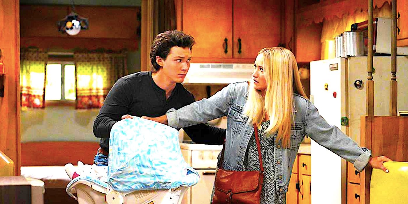 Montana Jordan's Georgie and Emily Osment's Mandy looking worried while holding a baby basket in a kitchen from Georgie & Mandy's First Marriage