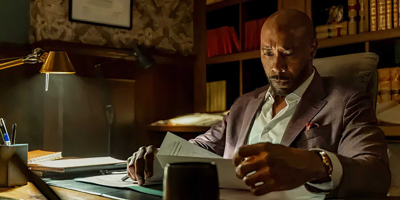 Morris Chestnut as Watson looking over documents in Watson