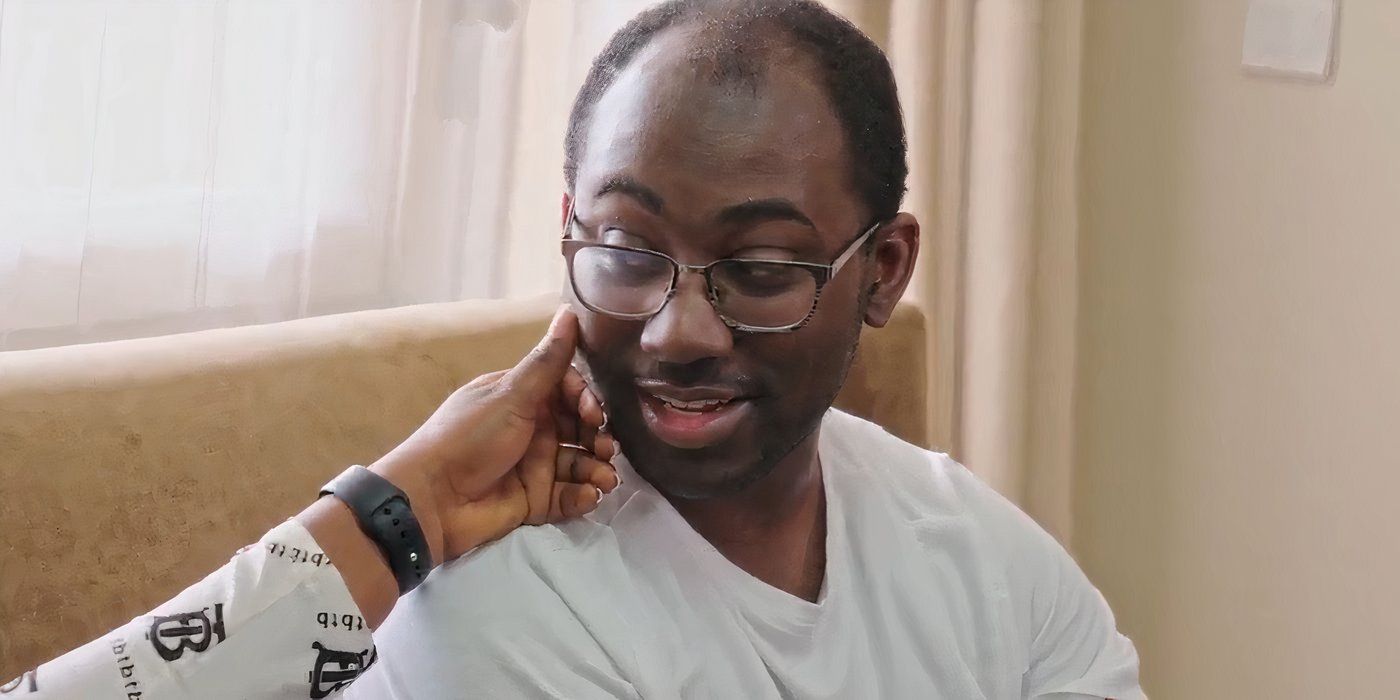 Niles Valentine in 90 Day Fiance in white shirt with Matilda caressing his cheek