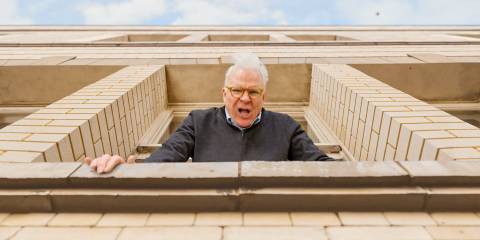 Charles (Steve Martin) looking out his window to check the height in Only Murders in the Building Season 4 Ep 10