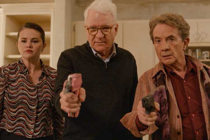 Mabel (Selena Gomez), Charles (Steve Martin), and Oliver (Martin Short) pointing weapons at Marshall P. Pope in Only Murders in the Building Season 4 Ep 10