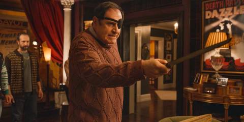 Vince Fish (Richard Kind) threatening them with a ham knife in Only Murders in the Building Season 4 Episode 8