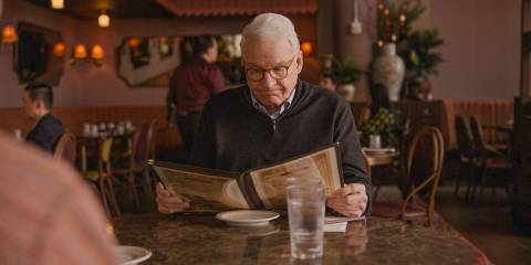 Charles (Steve Martin) looking annoyed while reading the menu in Only Murders in the Building Season 4 Episode 9