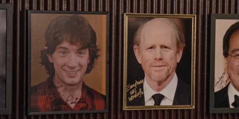 A photograph of the young Oliver (Martin Short) hanging next to a photo of Ron Howard in a restaurant in Only Murders in the Building Season 4 Episode 9