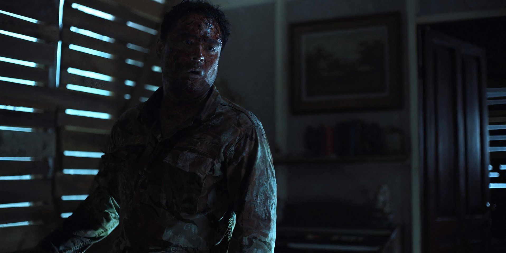 Francis (Sid Lucero) wearing a soldier's uniform and covered in blood in Outside