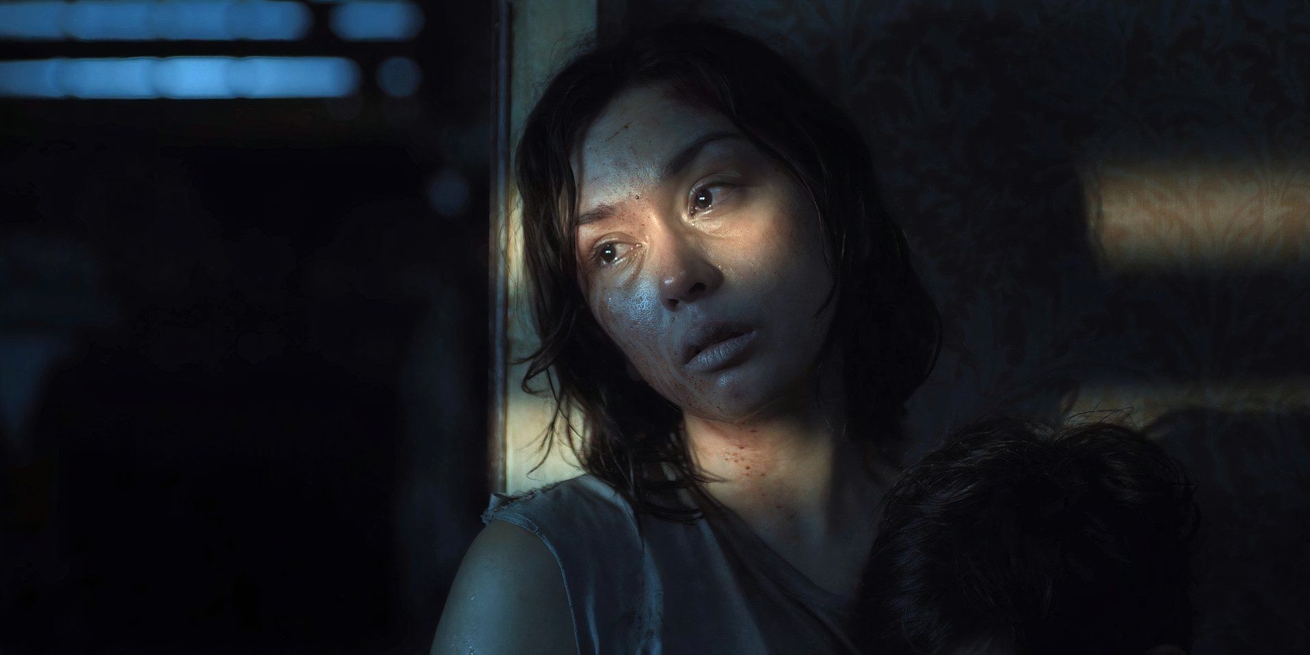 At the end of Outside, Iris (Beauty Gonzalez) looks out the window with a beam of light in her eyes