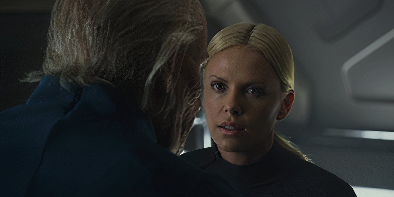 Meredith Vickers (Charlize Theron) looks at Peter Weyland (Guy Pearce) in Prometheus