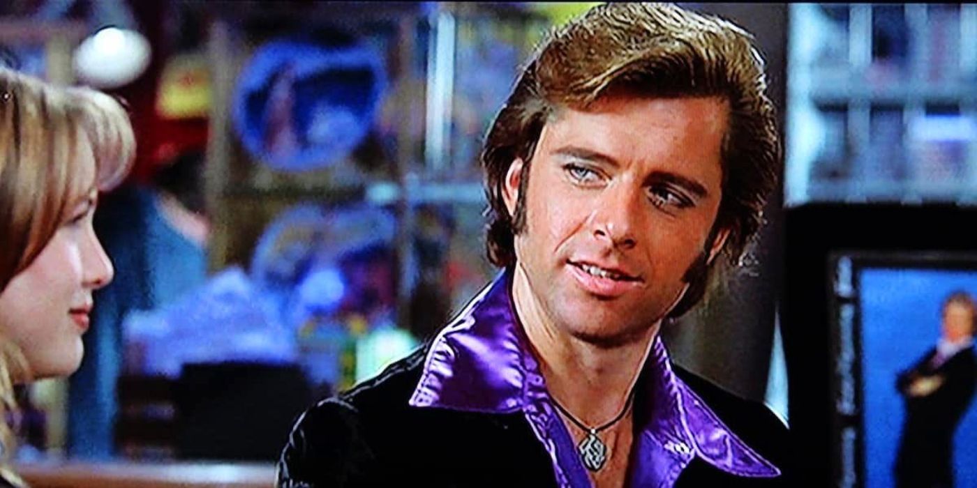 Rex Manning (Maxwell Caulfield) smiling at Gina (Renee Zellweger) in Empire Records.