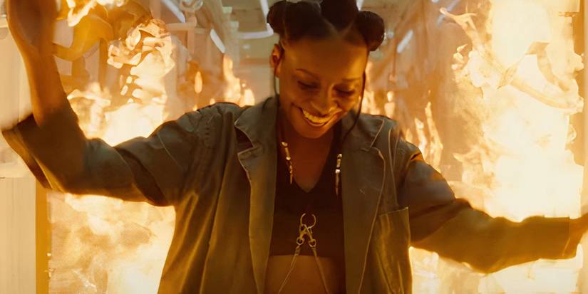 riri-wililams-smiling-as-a-fire-roars-behind-her-in-ironheart-trailer.jpg