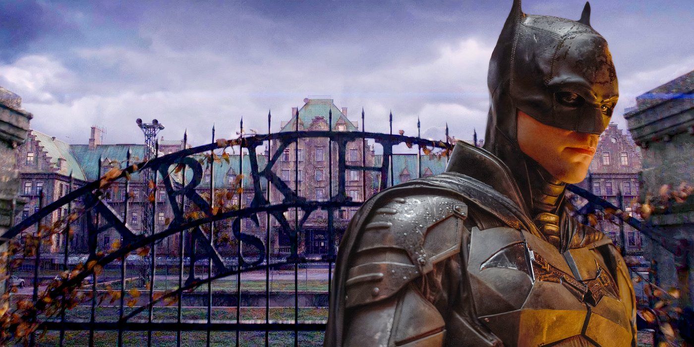 Robert Pattinson Batman in front of Arkham Asylum 