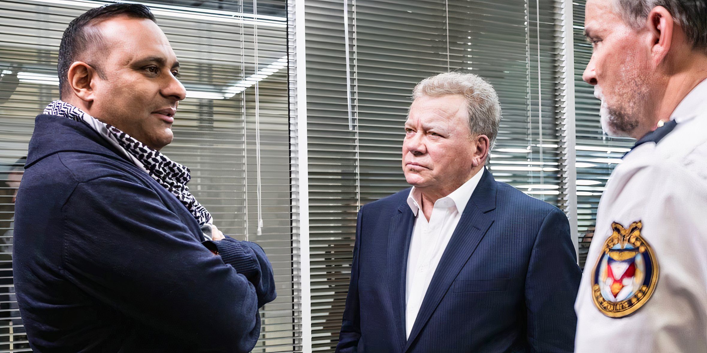 Russell Peters and William Shatner in the office of a police officer on The Indian Detective