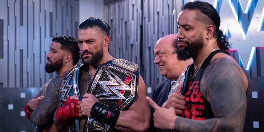 Tag Team Champions The Usos and Paul Heyman pose with WWE Undisputed Universal Champion Roman Reigns backstage