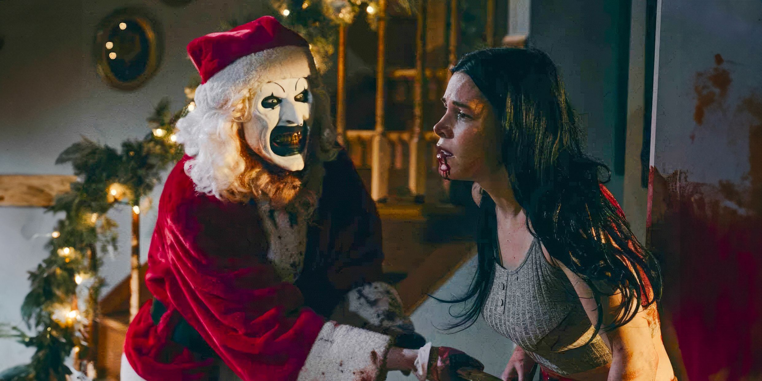 Art stabs a woman in the stomach while wearing a Santa suit in Terrifier 3.