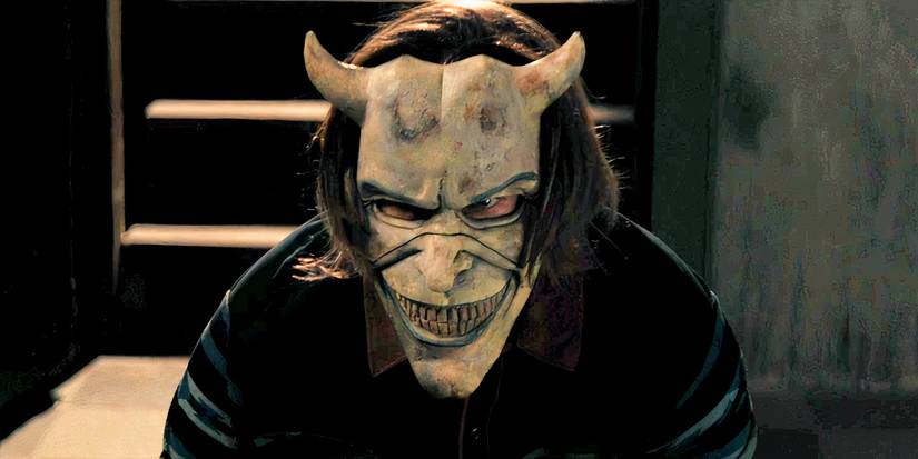 The Grabber wears a mask while visiting the young boy in the Black Phone