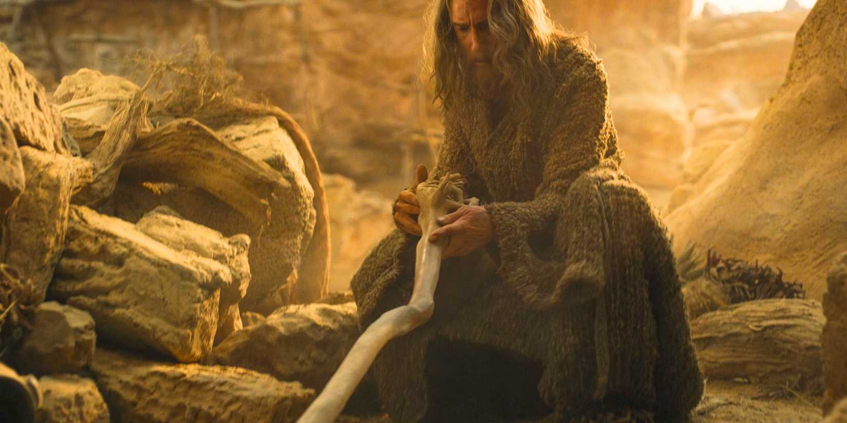 The Stranger (Daniel Weyman) finds his staff and acquires the name of Gandalf in The Lord of the Rings: The Rings of Power