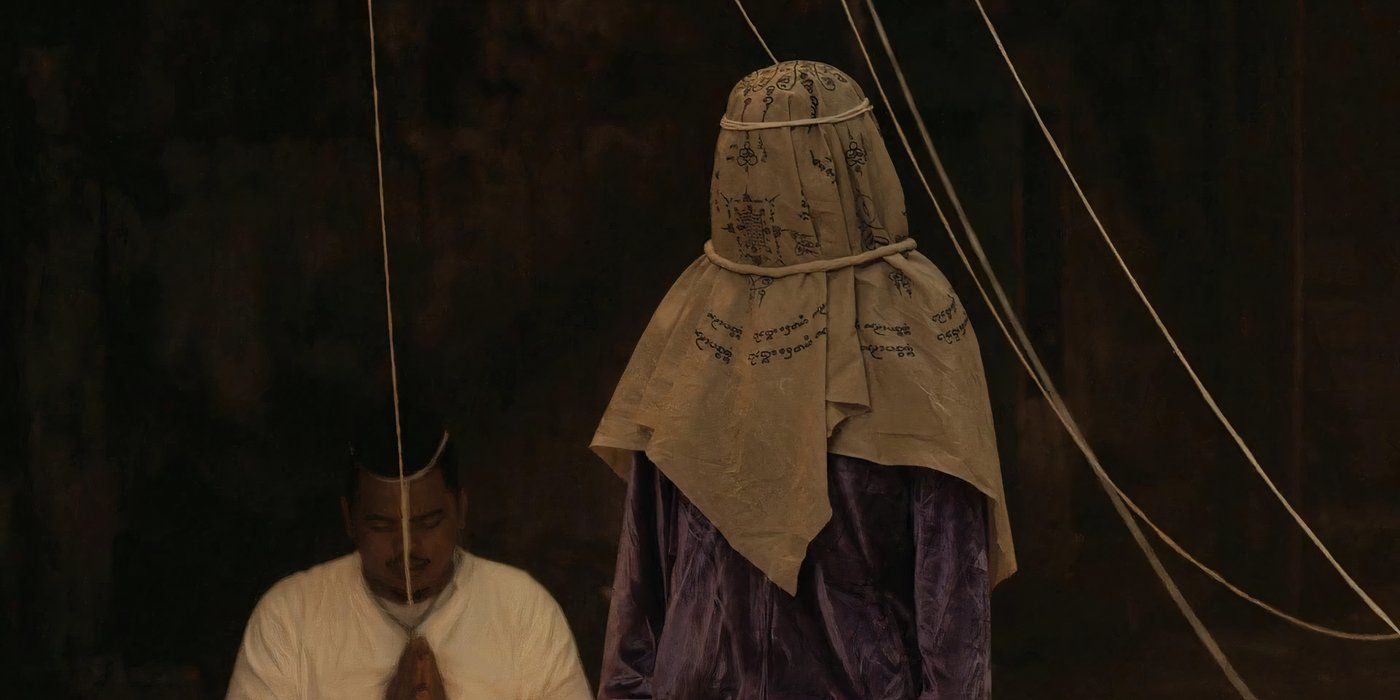 A creepy figure in a ceremonial head covering in the 2021 Thai horror movie The Medium